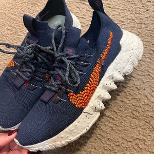 Navy blue and orange Nikes. Womens 9/ Men’s 7.5